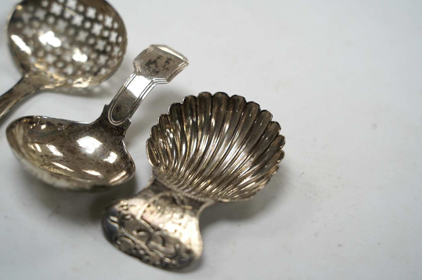 Four assorted silver caddy spoons, including Peter & Ann Bateman, London, 1793, 59mm, reeded handle, Joseph Wilmore?, Birmingham, 1807, pierced bowl, Alice & George Burrows, London, 1809 and curved handle John Lambe, Lon